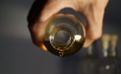 Hands applying warm oil during a relaxing massage therapy session.