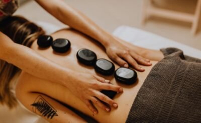 Therapist performing a traditional Thai massage using stretching techniques.